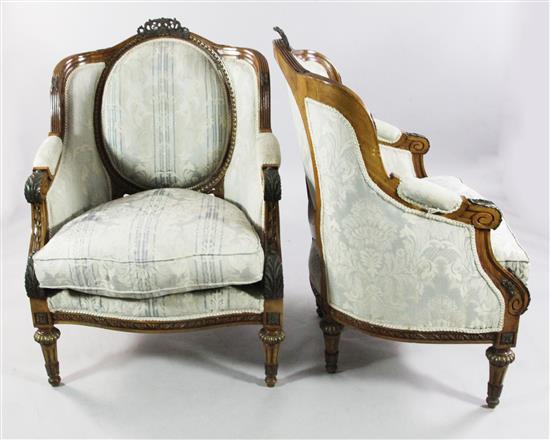 A pair of Louis XVI style stained beech and gilt bronze mounted armchairs,